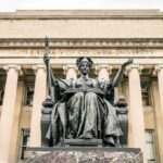 Alma Mater statue before a neoclassical library facade