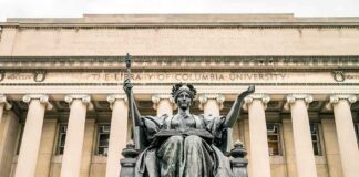 Alma Mater statue before a neoclassical library facade