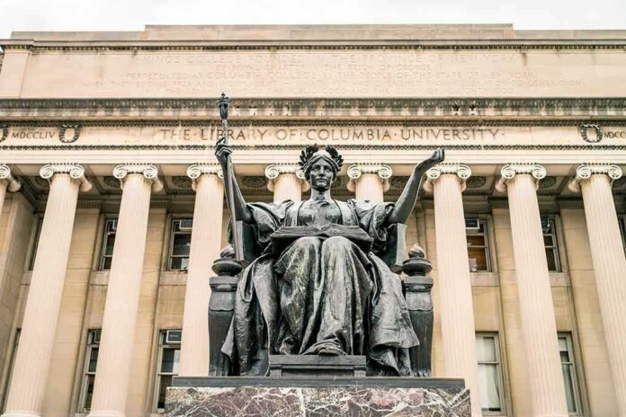 shutterstock_452410822 Alma Mater statue before a neoclassical library facade