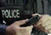 Judge SLAMS Raid Tactics – Factory Sweep Crosses Constitutional Line Police officer holding a body camera