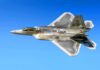 Stealth fighter jet in flight against a clear blue sky