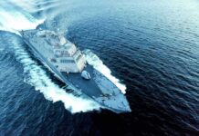 Naval warship cutting through open sea