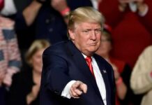 Donald Trump points toward the audience at an event