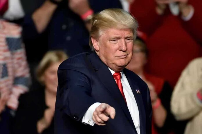Donald Trump points toward the audience at an event