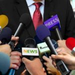 Ethics Firestorm Engulfs Federal Judges Press microphones surround a suited spokesperson