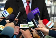 Ethics Firestorm Engulfs Federal Judges Press microphones surround a suited spokesperson