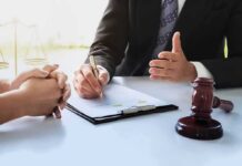 Lawyer and client discussing documents at a desk