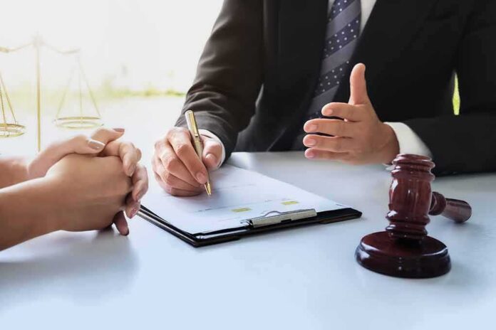 Lawyer and client discussing documents at a desk