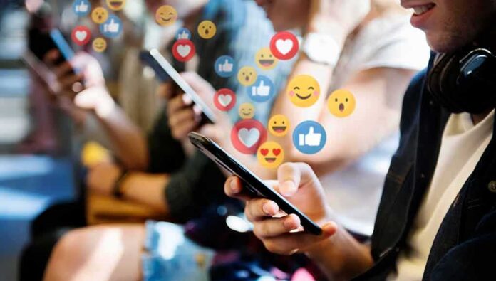 people using smartphones with social media reactions