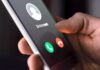 Campaign Calls Mapped – Chills Free Speech? Hand holding smartphone with incoming unknown call screen