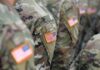 U.S. flag patches on camouflage military uniforms