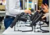 Gun Rights SURGE: Interstate Wall Falls Handguns displayed on stands at a trade show counter