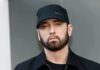 Eminem in a black cap and jacket