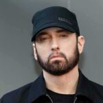 Detroit Shock: Eminem On Christian Track Eminem in a black cap and jacket
