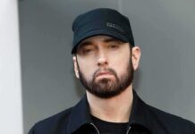 Eminem in a black cap and jacket