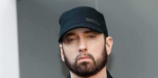 Eminem in a black cap and jacket