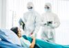 Court-Ordered Ivermectin: Survival Rate Stuns Gatekeepers Medical staff in hazmat suits attend to a patient in a hospital bed