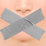 Feminist Fined For Words – Paris Fury Close-up face with mouth covered by crossed duct tape