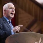 John Cornyn speaking at a podium