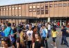 Teen Identity Trend FLATLINES – Why Now? Students gathered outside a school building entrance