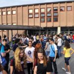 Teen Identity Trend FLATLINES – Why Now? Students gathered outside a school building entrance