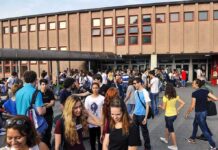 Teen Identity Trend FLATLINES – Why Now? Students gathered outside a school building entrance