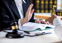 Ethics Bomb Over Slotkin’s Scare Tactics Lawyer refusing envelope during meeting at desk