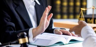 Lawyer refusing envelope during meeting at desk