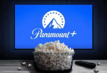 Judge Greenlights Hollywood Super-Merger Glass bowl of popcorn in front of Paramount+ on TV
