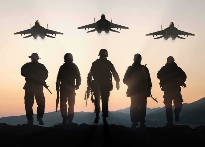 shutterstock_400783420 Soldiers walking with fighter jets flying overhead at sunset