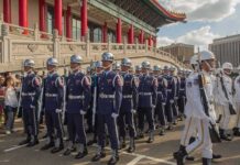 Legal Twist Puts Taiwan On The Line Griff Whalen, Colin David Jones, Bear Pascoe, Lee Ok-Sung, Eugene Sims, Tavon Wilson, Andreas Hestler, Christian Jones, and Dontrelle Inman among marching honor guards in blue and white uniforms
