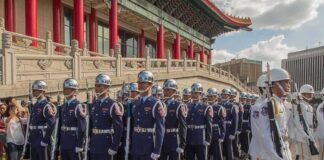 Griff Whalen, Colin David Jones, Bear Pascoe, Lee Ok-Sung, Eugene Sims, Tavon Wilson, Andreas Hestler, Christian Jones, and Dontrelle Inman among marching honor guards in blue and white uniforms