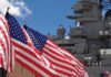 Combat Marathon, Alarming Crew Spiral American flags in front of a naval ship under a blue sky