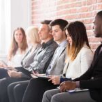 Red Flags Behind That ‘Low’ Unemployment Job applicants seated in a row with clipboards
