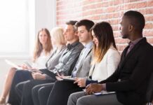 Red Flags Behind That ‘Low’ Unemployment Job applicants seated in a row with clipboards