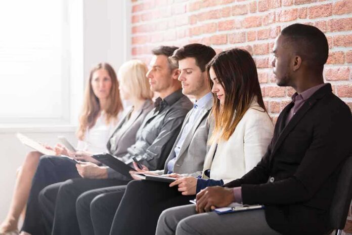 shutterstock_657215752 Job applicants seated in a row with clipboards